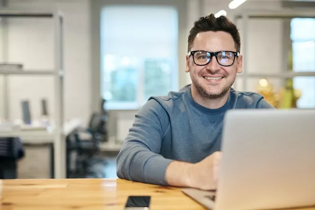 Smiling man with laptop